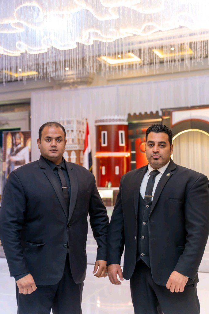 Golden Guard security professional handshake with client — trust and partnership