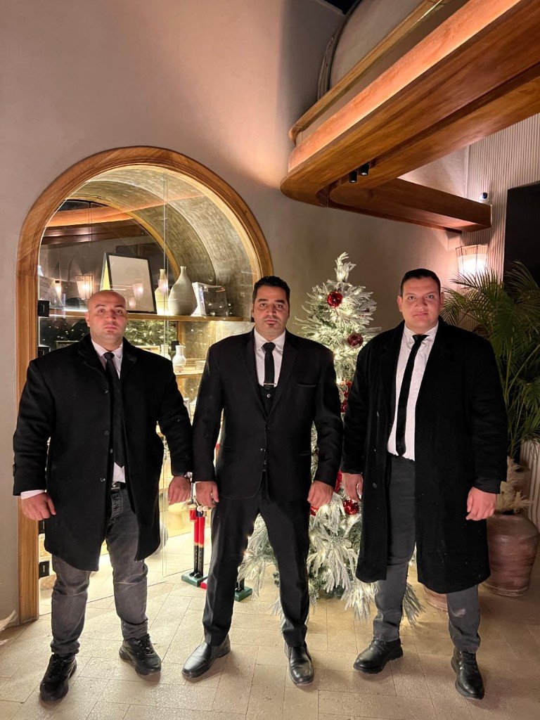 Golden Guard VIP protection team — three elite Egyptian security guards in luxury setting